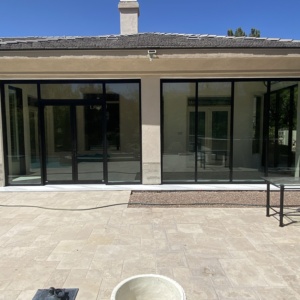 French aluminum door with storefront and low e glass enclosing patio